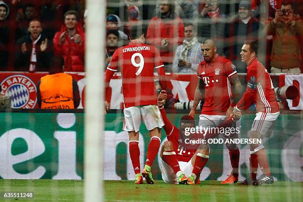 Bayern Munich's Spanish midfielder Thiago Alcantara celebrate scoring the 4-1 goal with his teammates during the UEFA Champions League round of...