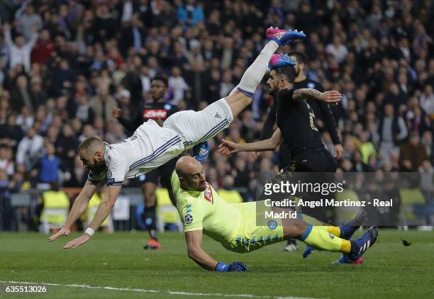 Karim Benzema of Real Madrid clashes with Pepe Reina of SSC Napoli during the UEFA Champions League Round of 16 first leg match between Real Madrid...