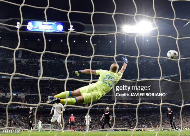 Napoli's goalkeeper from Spain Pepe Reina dives for the ball as Real Madrid's Brazilian midfielder Casemiro scores a goal during the UEFA Champions...