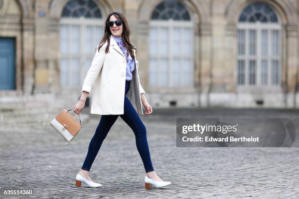 Sarah Benziane, fashion blogger from Les Colonnes de Sarah, wears a Sandro white coat, an Aliexpress blue top with floral print, Primark jeans, a...