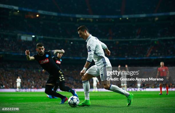 Cristiano Ronaldo of Real Madrid takes on Elseid Hysaj of Napoli during the UEFA Champions League Round of 16 first leg match between Real Madrid CF...