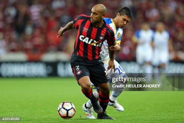 Jonathan of Brazil's Atletico Paranaense struggles for the ball with David Mendieta of Paraguay's Deportivo Capiata during their Libertadores Cup...