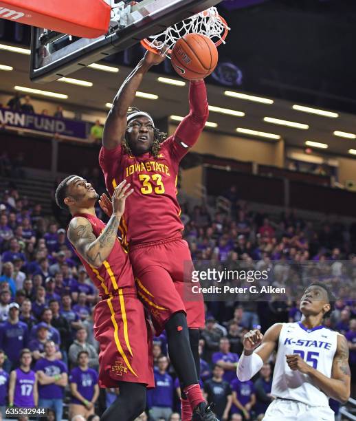 Forward Solomon Young of the Iowa State Cyclones dunks the ball over teammate Nick Weiler-Babb and guard Wesley Iwundu of the Kansas State Wildcats...