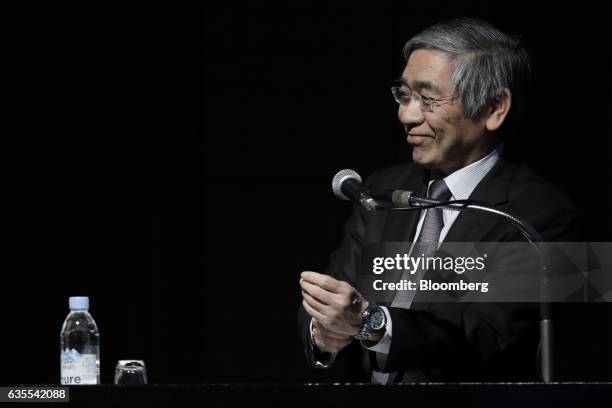 Haruhiko Kuroda, governor of the Bank of Japan , smiles after delivering a keynote speech at an international conference hosted by the Deposit...