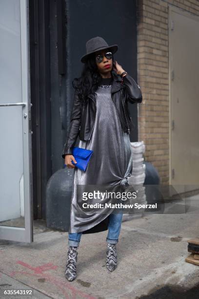 Tania Cascilla is seen attending Vivienne Tam during New York Fashion Week while wearing a silver dress with blue bag and grey hat on February 15,...