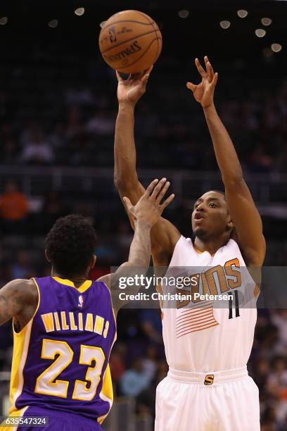 Brandon Knight of the Phoenix Suns attempts a shot over Louis Williams of the Los Angeles Lakers during the second half of the NBA game at Talking...