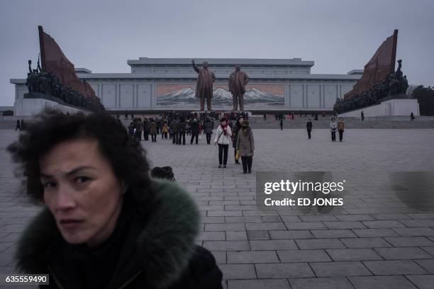 People visit the statues of late North Korean leaders Kim Il-Sung and Kim Jong-Il to pay their respects on the occasion of the 75th anniversary of...