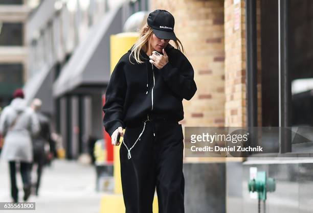 Guest is seen wearing a black hoodie, black oversized pants and Balenciaga hat outside the Anna Sui show during New York Fashion Week on February 15,...
