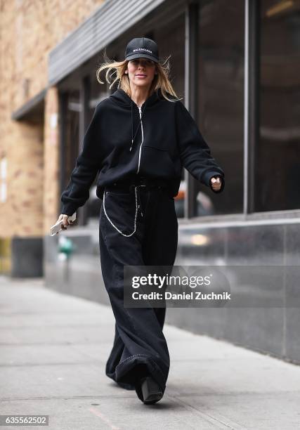 Guest is seen wearing a black hoodie, black oversized pants and Balenciaga hat outside the Anna Sui show during New York Fashion Week on February 15,...