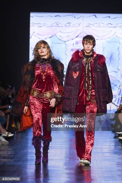 Model and model Joel Wolfe walk the runway at the Anna Sui Fall/Winter 2017 Show at Skylight Clarkson Sq on February 15, 2017 in New York City.