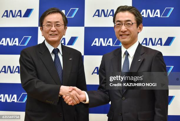 All Nippon Airways outgoing CEO and president Osamu Shinobe poses with newly-named president Yuji Hirako following a press conference in Tokyo on...