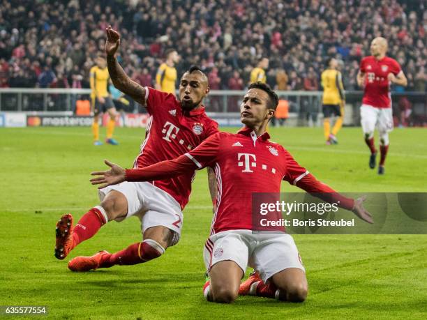 Thiago Alcantara of FC Bayern Muenchen celebrates with team mate Arturo Vidal after scoring his team's fourth goal during the UEFA Champions League...