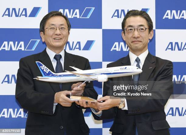Yuji Hirako , a corporate executive officer and director of ANA Holdings Inc., poses for photos with All Nippon Airways Co. President Osamu Shinobe...