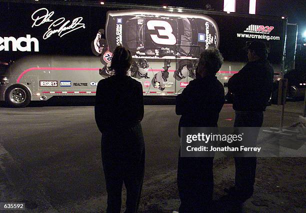 Saddened fans watch the departure of Dale Earnhardt's car hauler as it leaves the track. Dale Earnhardt later succumbed to the injuries he recieved...