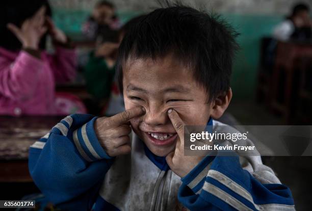 Left behind' child Luo Lie does eye exercises with classmates at a local school on December 16, 2016 in Anshun, China. Like millions of Chinese...