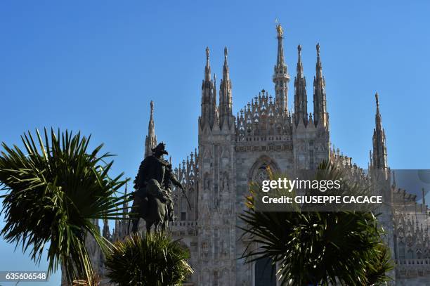 Newly planted palm trees are pictured in front of Italy's landmark, the Milan Cathedral, at the Piazza del Duomo in Milan on February 16, 2017. The...