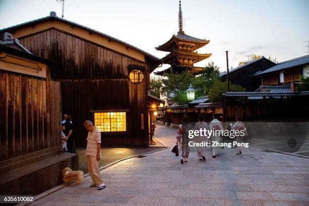 Young girls, dressed in Kimono, walking on the alley of Kiyomizu zaka, which is an traditional Japanese neighborhood outside Kiyomizu dera. Kiyomizu...