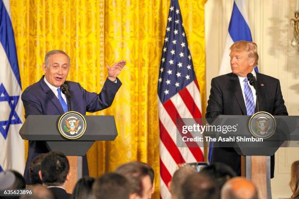 President Donald Trump listens to Israel Prime Minister Benjamin Netanyahu during a joint news conference at the East Room of the White House...