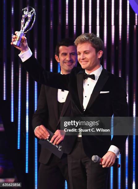 Driver and Laureus Ambassador Nico Rosberg of Germany with his Laureus World Breakthrough of the Year Award as Academy Member Luis Figo looks on...