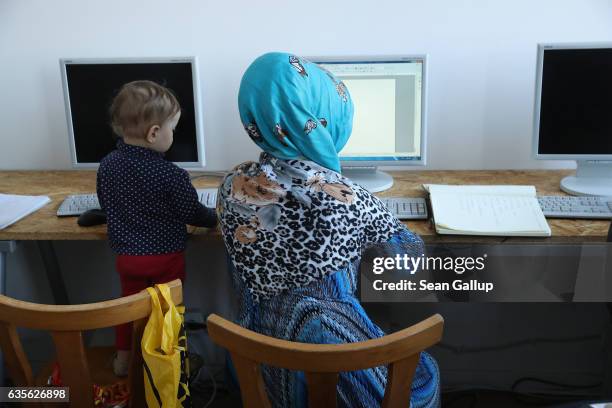 Young woman from Afghanistan, who preferred not to show her face to the camera, attends a class offering literacy and basic computer and Internet...