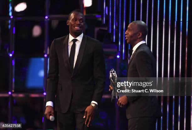 Athlete Usain Bolt of Jamaica accepts his Laureus World Sportsman of the Year Award from Laureus Academy member Michael Johnson during the 2017...