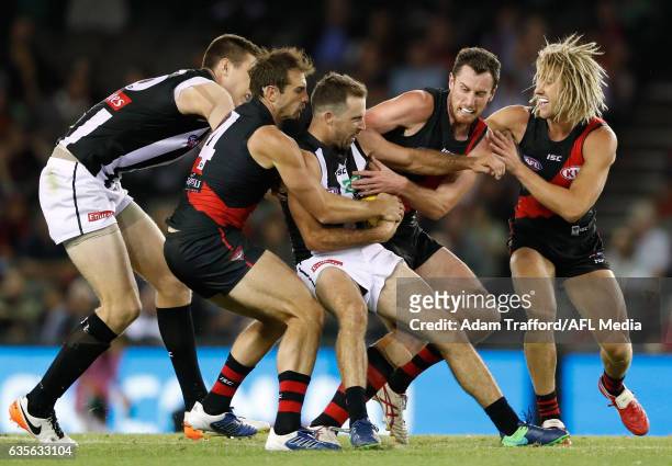 Steele Sidebottom of the Magpies is tackled by Jobe Watson, Matthew Leuenberger and Dyson Heppell of the Bombers during the AFL 2017 JLT Community...