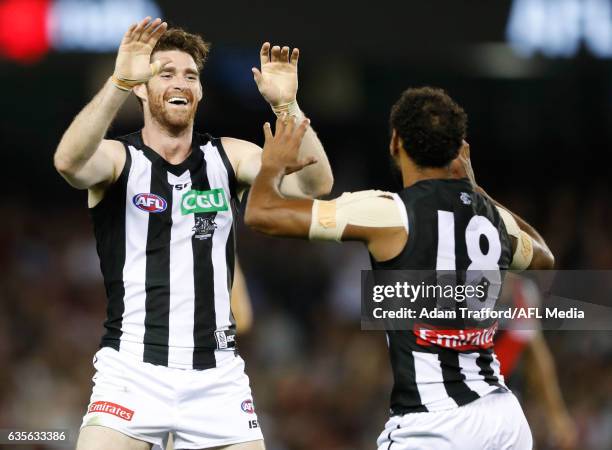 Travis Varcoe of the Magpies celebrates a goal with Tyson Goldsack of the Magpies during the AFL 2017 JLT Community Series match between the...