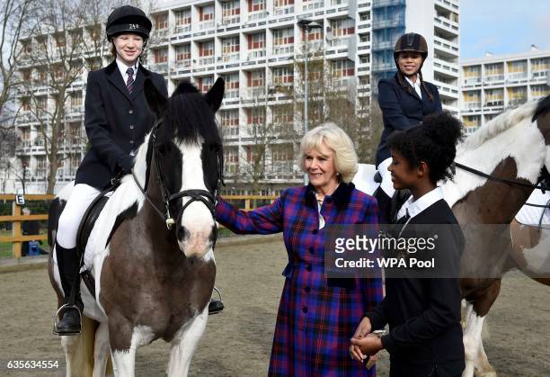 Camilla, Duchess of Cornwall meets riders during her visit to the Ebony Horse Club during her visit to the Ebony Horse Club in Brixton to celebrate...