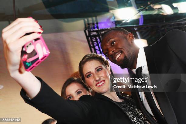 Laureus Ambassador Missy Franklin takes a picture with Laureus World Sportsman of the Year Award nominee Athlete Usain Bolt of Jamaica at the 2017...