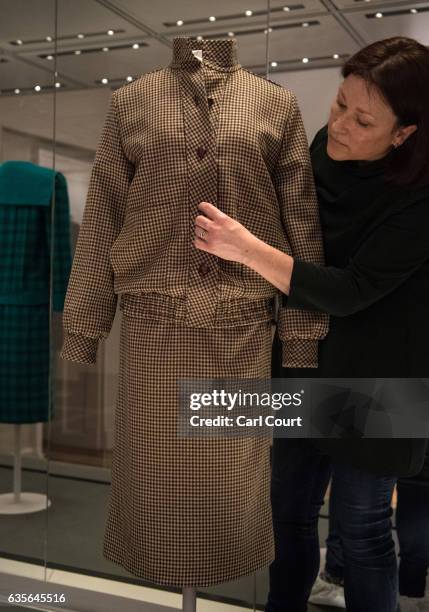 Member of staff poses with a brown tweed day suit designed by Bill Pashley and worn by Diana on her honeymoon in Balmoral in 1981 during a preview...