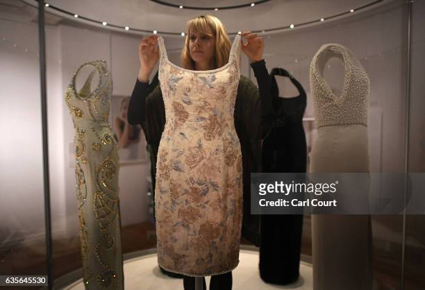 Member of staff poses with a dress designed by Catherine Walker, which Princess Diana wore to a Christies Auction Gala in New York in 1997, during a...
