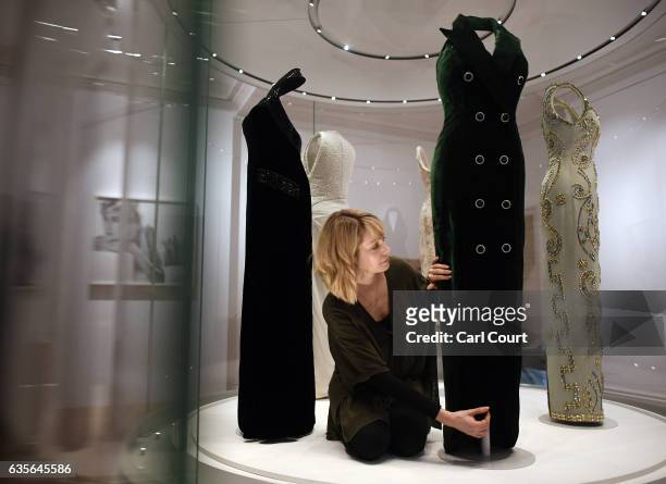 Member of staff poses with a 1992 Catherine Walker green silk velvet evening dress with velvet and diamante buttons worn for Diana's Vanity Fair...