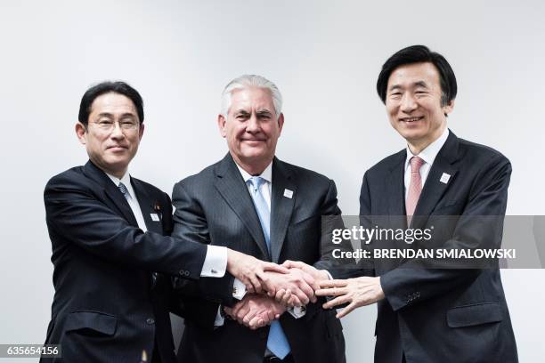Japan's Foreign Minister Fumio Kishida , US Secretary of State Rex Tillerson and South Korean Foreign Minister Yun Byung-Se shake hands before a...
