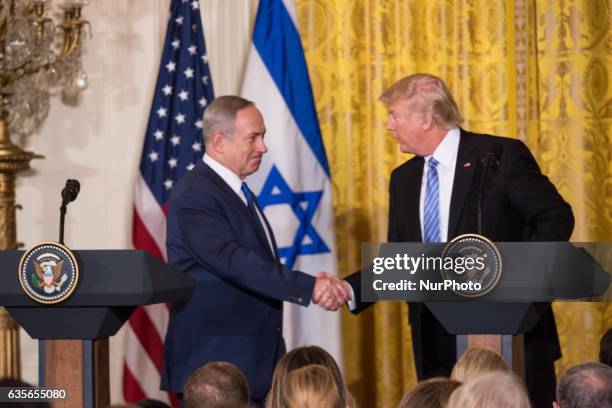 President Donald Trump and Israeli Prime Minister Benjamin Netanyahu shake hands during a joint press conference in the East Room of the White House...