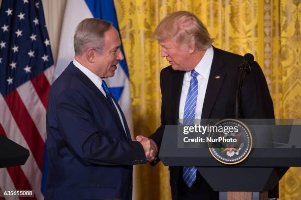 President Donald Trump and Israeli Prime Minister Benjamin Netanyahu shake hands during a joint press conference in the East Room of the White House...