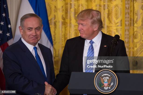 President Donald Trump and Israeli Prime Minister Benjamin Netanyahu shake hands during a joint press conference in the East Room of the White House...