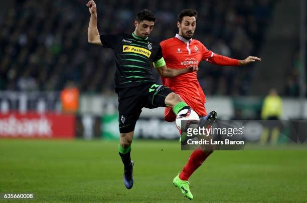 Lars Stindl of Moenchengladbach is challenged by Davide Astori of Fiorentina during the UEFA Europa League Round of 32 first leg match between...