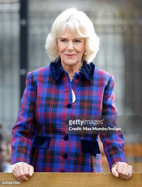 Camilla, Duchess of Cornwall watches a horse riding display during a visit to the Ebony Horse Club riding centre to celebrate the club's 21st...