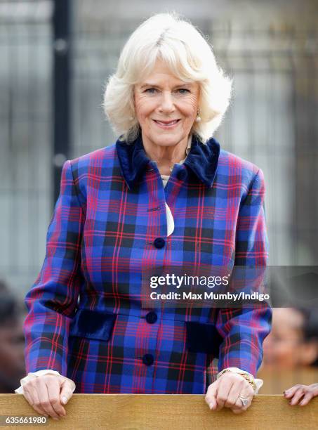 Camilla, Duchess of Cornwall watches a horse riding display during a visit to the Ebony Horse Club riding centre to celebrate the club's 21st...