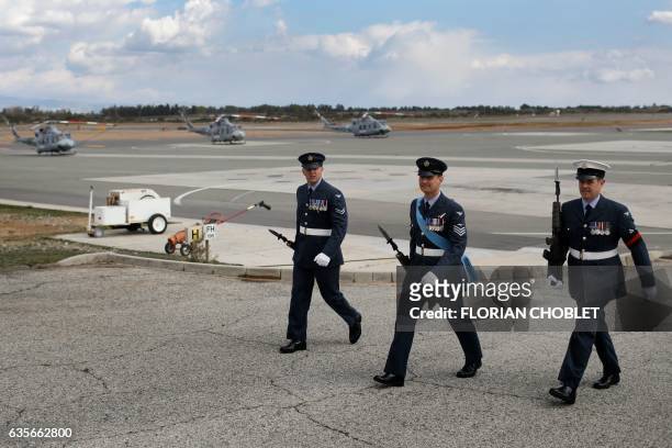 Members of the RAF Akrotiri multi-role 84 Squadron walk in front of Griffin HAR2 helicopters at the end of a parade marking the centenary of the 84...