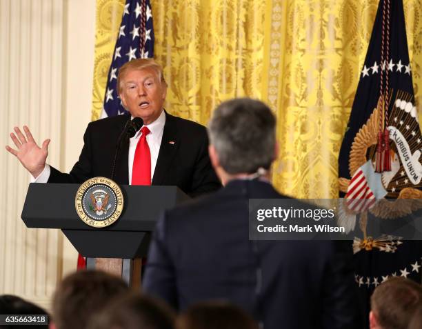 President Donald Trump answers a question from CNN's Jim Acosta during a news conference announcing Alexander Acosta as the new Labor Secretary...