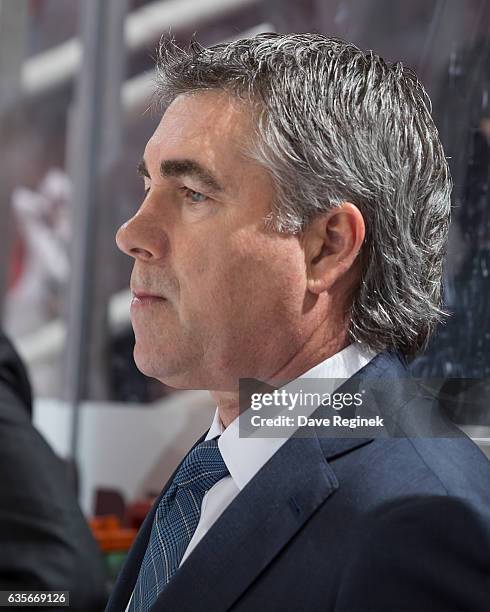 Head coach Dave Tippett of the Arizona Coyotes watches the action from the bench during an NHL game against the Detroit Red Wings at Joe Louis Arena...