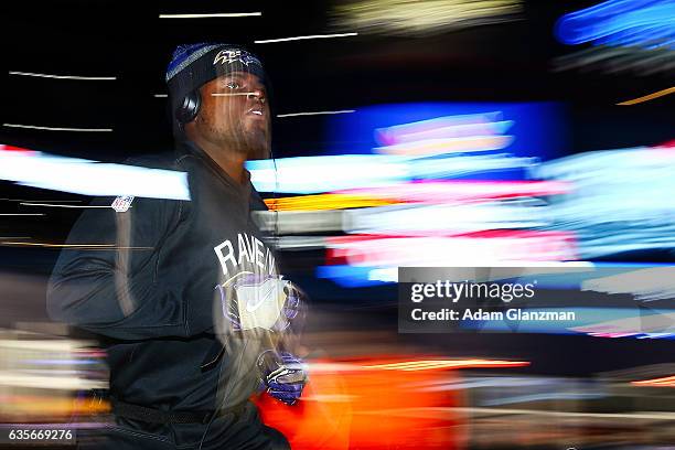 Marqueston Huff of the Baltimore Ravens runs onto the field before the game against the New England Patriots at Gillette Stadium on December 12, 2016...