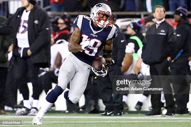 Malcolm Mitchell of the New England Patriots runs with the ball during the first half against the Baltimore Ravens at Gillette Stadium on December...