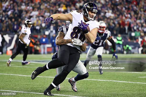 Nick Boyle of the Baltimore Ravens is tackled during the game against the New England Patriots at Gillette Stadium on December 12, 2016 in Foxboro,...