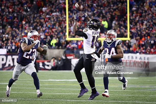 Breshad Perriman of the Baltimore Ravens is tackled by Patrick Chung and Cyrus Jones of the New England Patriots during the second half of their game...