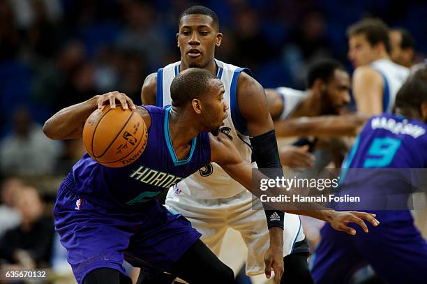 Kris Dunn of the Minnesota Timberwolves guards against Rasheed Sulaimon of the Charlotte Hornets during the preseason game on October 21, 2016 at...