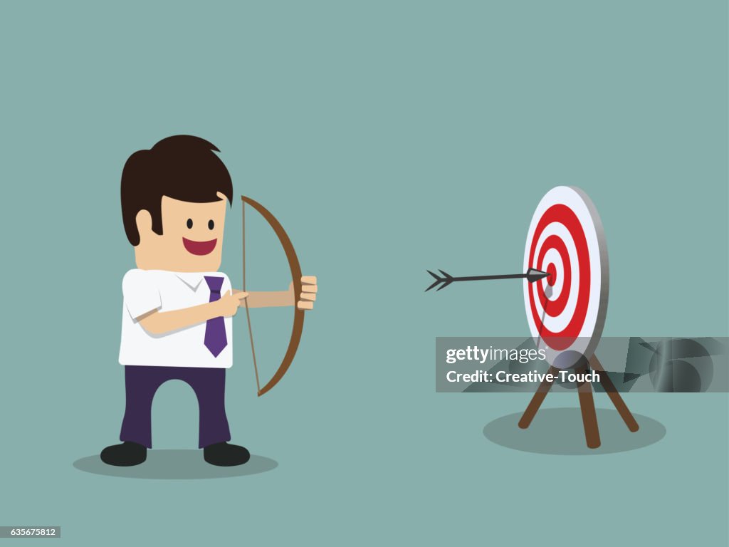 Businessman hit a target with darts