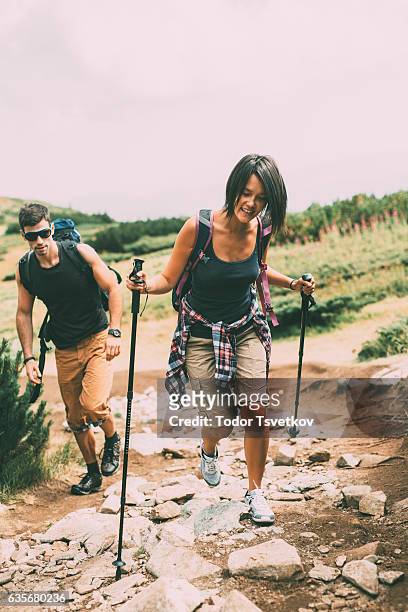 hikers in the mountain - muddy footpath stock pictures, royalty-free photos & images
