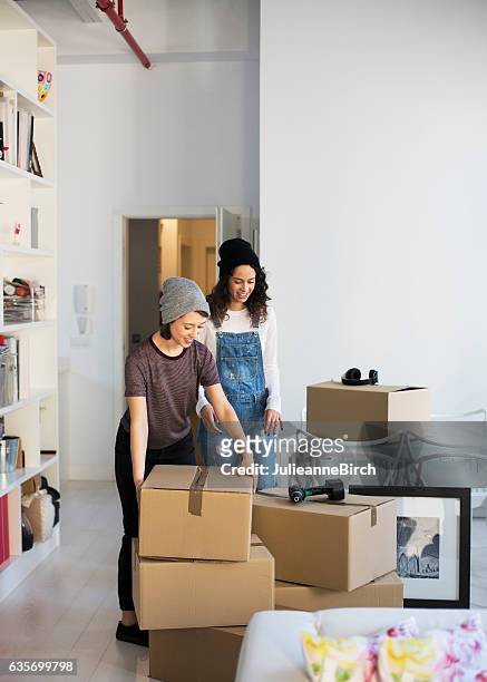 same sex couple moving home - lesbian couple stock pictures, royalty-free photos & images